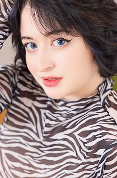 Sugar Ann teases in sheer zebra top, black stockings, moans soft as silk while posing on the desk