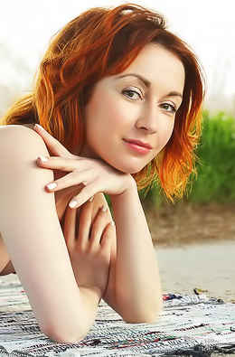 Redhead cutie relaxes naked outdoors