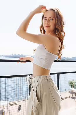 Margot Ferns Starts To Undress At The Doorway To The Balcony