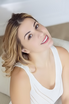 Alice Kelly Dark-eyed Siren Smiles Enticingly As The Straps Slide From Her Shoulders