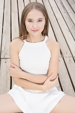 Sasha Quinn Smiling Playfully As Her Short Skirt Flips Up To Reveal She’s Not Wearing Panties