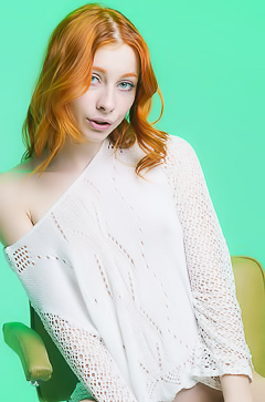 Carolina Sun Seductively Poses Nude In A White Sweater On A Green Chair With Legs Spread